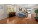 Bright living room with hardwood floors, large windows, and views of the backyard pool at 9819 Bridgeton Dr, Tampa, FL 33626