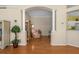 Elegant living room featuring hardwood floors, columns, and archway leading to a relaxing seating area at 9819 Bridgeton Dr, Tampa, FL 33626