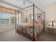 Cozy main bedroom features natural light, four poster bed, and relaxing views at 9819 Bridgeton Dr, Tampa, FL 33626