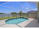 Screened pool with a water feature, beautiful lake views, and ample patio space for outdoor enjoyment at 9819 Bridgeton Dr, Tampa, FL 33626