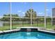 Backyard screened pool with a water feature and a lovely view of the neighborhood pond at 9819 Bridgeton Dr, Tampa, FL 33626