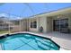 Enjoy the backyard of this home with a screened-in pool and patio with multiple seating areas at 9819 Bridgeton Dr, Tampa, FL 33626