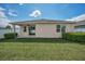 Lovely backyard featuring a covered patio, lush lawn, privacy fence, and home's exterior at 12055 Lake Blvd, New Port Richey, FL 34655