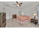 Spacious main bedroom showcases a ceiling fan, wood-look flooring and a light, airy feel at 12055 Lake Blvd, New Port Richey, FL 34655