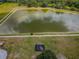 Aerial view of the community pond featuring a walking path and a playground in the background at 12055 Lake Blvd, New Port Richey, FL 34655