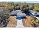Aerial view of the home, showing the roof, pool, and surrounding trees at 12242 Greenwood St, Brooksville, FL 34613