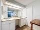 Bright bathroom featuring double sinks, granite countertops, modern fixtures, and a large mirror at 12242 Greenwood St, Brooksville, FL 34613