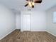 Bedroom featuring wood-look tile flooring, a ceiling fan, and a closet at 12242 Greenwood St, Brooksville, FL 34613