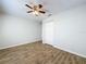 Bright bedroom with wood-look tile flooring, a ceiling fan, and neutral paint at 12242 Greenwood St, Brooksville, FL 34613