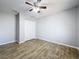 A comfortable bedroom with a ceiling fan and wood-look flooring at 12242 Greenwood St, Brooksville, FL 34613