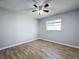 Bedroom featuring wood-look tile flooring, a ceiling fan, and a window at 12242 Greenwood St, Brooksville, FL 34613