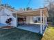 Covered carport area with a workbench and ample parking space at 12242 Greenwood St, Brooksville, FL 34613