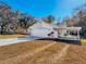 Side view of home showing the two-car garage and a covered carport at 12242 Greenwood St, Brooksville, FL 34613