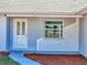 Charming front entry featuring a white door and a cozy window at 12242 Greenwood St, Brooksville, FL 34613