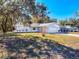 Well-maintained home featuring an attached two-car garage and a spacious front yard at 12242 Greenwood St, Brooksville, FL 34613