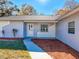 Inviting front exterior with a freshly landscaped yard and a charming entry at 12242 Greenwood St, Brooksville, FL 34613