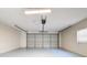An empty garage with a painted floor and automatic door opener at 12242 Greenwood St, Brooksville, FL 34613