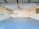 Spacious garage with a painted floor and space for storage at 12242 Greenwood St, Brooksville, FL 34613