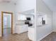 Modern kitchen with white cabinets, granite countertops, and stainless steel appliances, enhanced by a skylight at 12242 Greenwood St, Brooksville, FL 34613