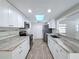 Well-lit kitchen with granite countertops, stainless steel appliances, and a skylight for added natural light at 12242 Greenwood St, Brooksville, FL 34613