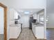 Updated kitchen with sleek stainless steel appliances, granite counters, and bright skylight for ample natural light at 12242 Greenwood St, Brooksville, FL 34613
