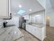 Bright kitchen with stainless steel appliances, granite countertops, and a skylight, offering modern conveniences at 12242 Greenwood St, Brooksville, FL 34613