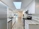 Kitchen view showcases stainless steel appliances, granite countertops, and a sun-lit atmosphere at 12242 Greenwood St, Brooksville, FL 34613