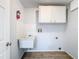 Utility room with a sink, cabinets, and tile backsplash at 12242 Greenwood St, Brooksville, FL 34613