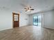 View of the open concept living room with a ceiling fan and sliding glass doors leading to the lanai at 12242 Greenwood St, Brooksville, FL 34613
