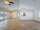 Bright, open living room with wood-look tile flooring and a vaulted ceiling at 12242 Greenwood St, Brooksville, FL 34613
