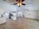 Inviting open floor plan with a stylish kitchen, stainless steel appliances, and wood-look flooring at 12242 Greenwood St, Brooksville, FL 34613