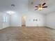 Bright living room featuring high ceilings and stylish wood-look tile floors, perfect for modern living at 12242 Greenwood St, Brooksville, FL 34613