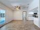 Open-concept living area with wood-look floors, connecting seamlessly to the adjacent outdoor screened in lanai at 12242 Greenwood St, Brooksville, FL 34613