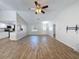 Cozy living area with wood-look flooring, ceiling fan, and kitchen view at 12242 Greenwood St, Brooksville, FL 34613