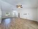 Inviting living room featuring wood-look flooring, ceiling fan, and ample natural light at 12242 Greenwood St, Brooksville, FL 34613