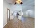 Spacious open floor plan with a modern kitchen featuring white cabinetry and stainless steel appliances at 12242 Greenwood St, Brooksville, FL 34613