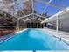 Inviting screen-enclosed pool features sparkling water, perfect for relaxation and recreation in a private backyard oasis at 12242 Greenwood St, Brooksville, FL 34613