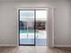 View from inside house, looking through sliding glass door out to the screened in lanai and pool at 12242 Greenwood St, Brooksville, FL 34613