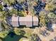 Aerial view of community buildings surrounded by manicured landscaping, parking, and serene natural pond at 13103 Cypress Hill Dr # B2, Hudson, FL 34669