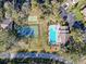 Overhead view of community amenities featuring a pool, tennis courts, and convenient parking at 13103 Cypress Hill Dr # B2, Hudson, FL 34669