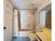 Tiled bathroom featuring shower-over-tub combination and vanity at 13103 Cypress Hill Dr # B2, Hudson, FL 34669