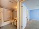 Bathroom featuring a shower over tub, vanity with a large mirror, and tile flooring at 13103 Cypress Hill Dr # B2, Hudson, FL 34669