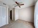 Bright bedroom with ceiling fan, closets, and ample closet space at 13103 Cypress Hill Dr # B2, Hudson, FL 34669