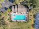 Aerial view of the sparkling community pool and spa surrounded by lounge chairs and lush landscaping at 13103 Cypress Hill Dr # B2, Hudson, FL 34669