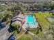 Aerial view of the sparkling community pool and spa surrounded by lounge chairs and lush landscaping at 13103 Cypress Hill Dr # B2, Hudson, FL 34669