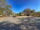 Community entrance gate featuring brick paved road and well-manicured landscaping under a clear sky at 13103 Cypress Hill Dr # B2, Hudson, FL 34669