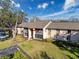 Well-maintained building exterior with lush landscaping, parking, and clear blue sky at 13103 Cypress Hill Dr # B2, Hudson, FL 34669