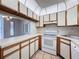 Well-equipped kitchen with white appliances and views to the living space at 13103 Cypress Hill Dr # B2, Hudson, FL 34669