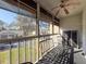 Enjoy the view from this screened-in lanai, equipped with seating and a ceiling fan for comfort at 13103 Cypress Hill Dr # B2, Hudson, FL 34669