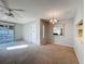 Spacious living room with carpet, ceiling fan and a sliding glass door to a screened lanai at 13103 Cypress Hill Dr # B2, Hudson, FL 34669